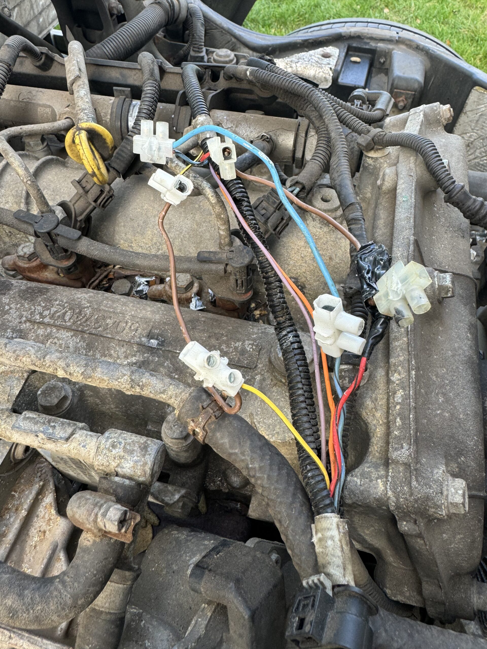 HGV engine bay wiring loom exposed after cab tilt — fault trace in progress
